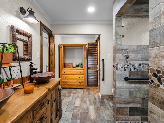 bathroom with vanity, wood-type flooring, and ornamental molding