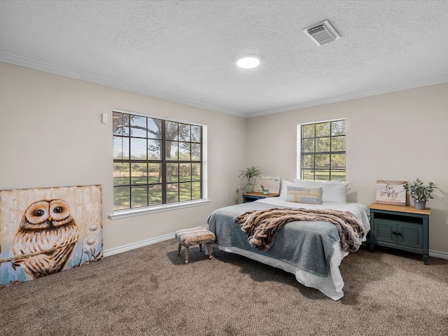 carpeted bedroom with ornamental molding and a textured ceiling