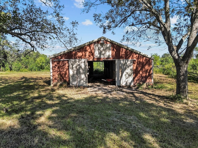 view of outbuilding featuring a yard