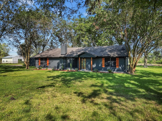 rear view of property with a lawn