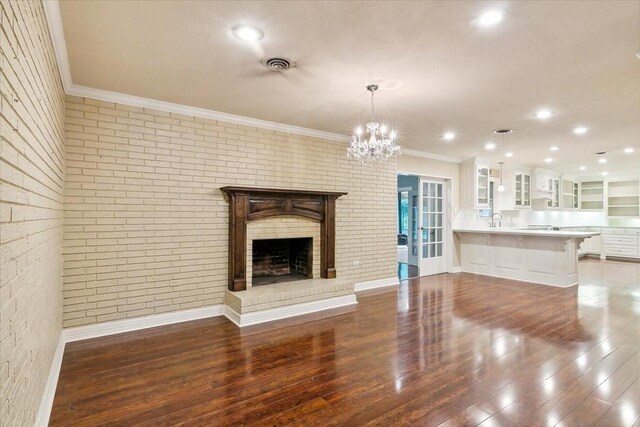 3301 Pelican St, Orange, TX 77630 - unfurnished living room with wood finished floors, a sink, ornamental molding, and visible vents