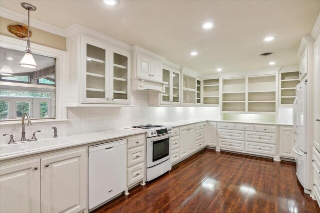 3301 Pelican St, Orange, TX 77630 - kitchen with white appliances, under cabinet range hood, a sink, visible vents, and white cabinets