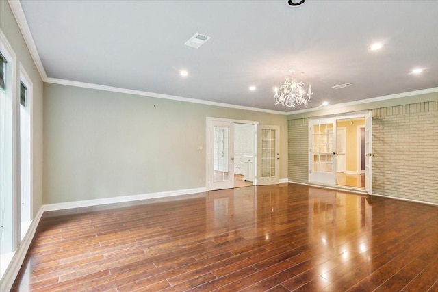 3301 Pelican St, Orange, TX 77630 - spare room featuring baseboards, french doors, wood finished floors, and a chandelier