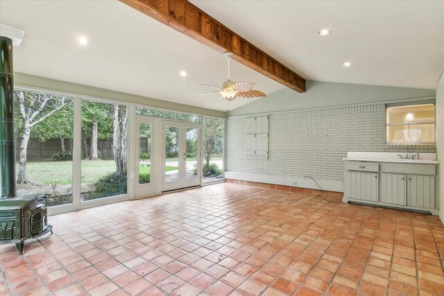 3301 Pelican St, Orange, TX 77630 - unfurnished sunroom with french doors, a sink, beamed ceiling, and a wood stove