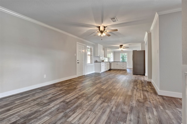 unfurnished living room with hardwood / wood-style flooring, ceiling fan, and ornamental molding