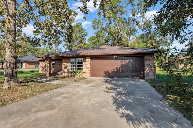 view of front of property with a garage and a front lawn