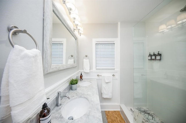 bathroom with a shower with door and vanity