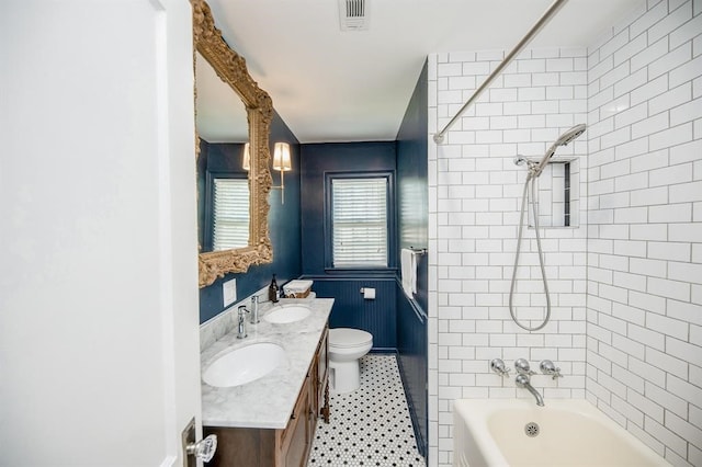 full bathroom with tiled shower / bath, vanity, toilet, and tile patterned flooring