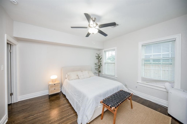 bedroom featuring dark hardwood / wood-style flooring, radiator heating unit, and ceiling fan