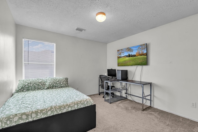 carpeted bedroom with a textured ceiling