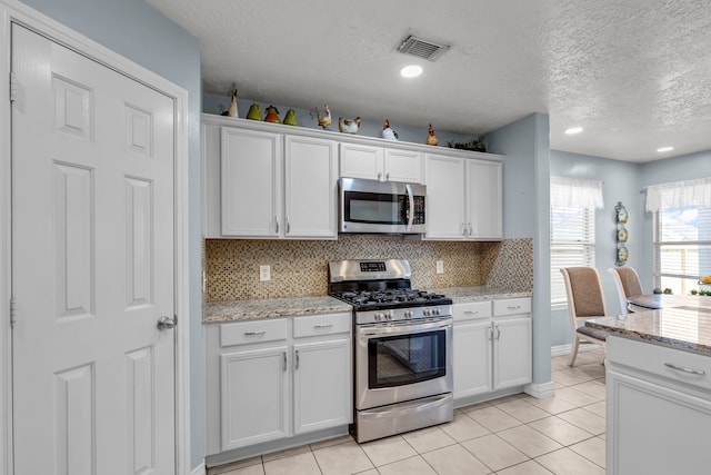 kitchen featuring white cabinets and appliances with stainless steel finishes