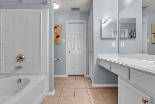 bathroom with a textured ceiling, vanity, and tile patterned floors