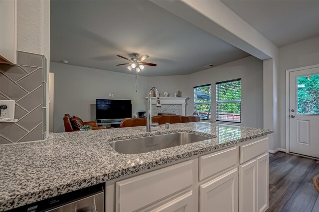 kitchen featuring a healthy amount of sunlight, white cabinetry, dark hardwood / wood-style floors, and sink