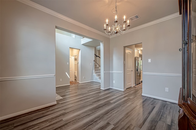 unfurnished dining area featuring a notable chandelier, ornamental molding, and hardwood / wood-style flooring