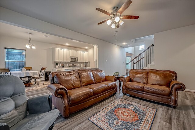 living room with ceiling fan and hardwood / wood-style floors