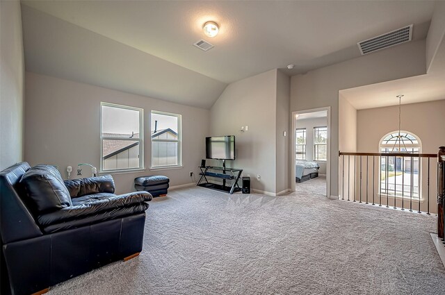 carpeted living room with lofted ceiling