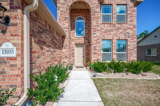 doorway to property with a yard