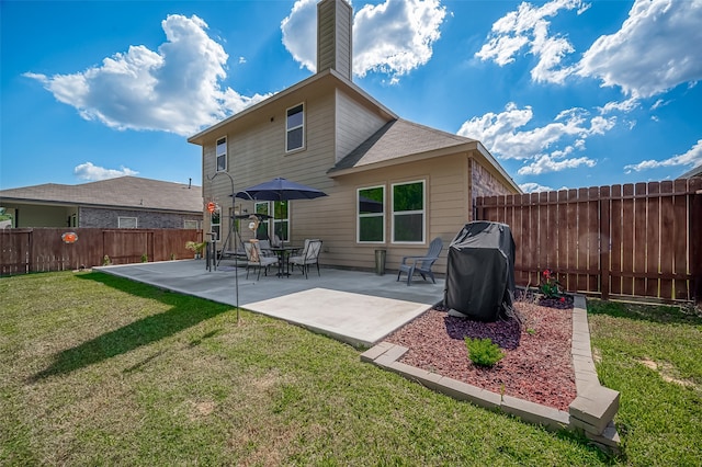 back of house with a patio and a yard