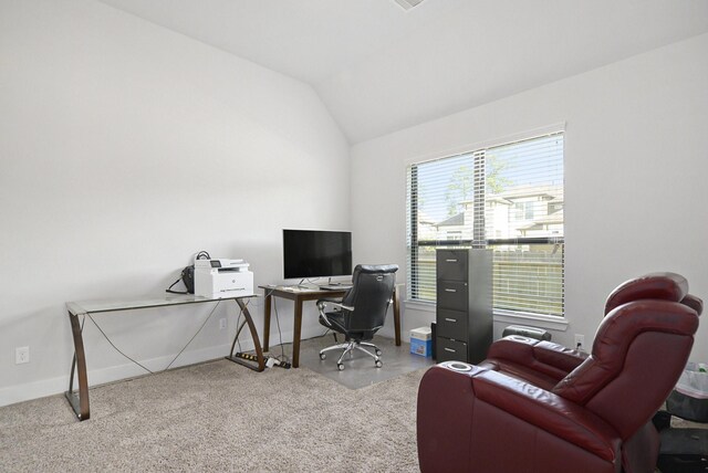 carpeted home office with lofted ceiling