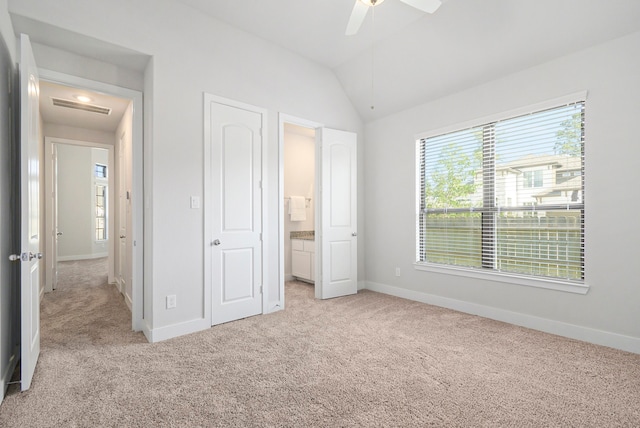 unfurnished bedroom with light carpet, lofted ceiling, and ceiling fan