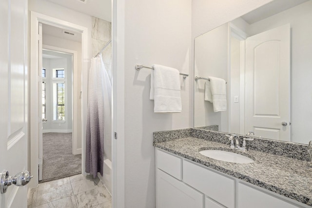 full bath with shower / tub combo, visible vents, baseboards, marble finish floor, and vanity