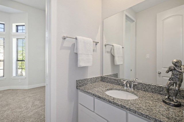 bathroom with baseboards and vanity