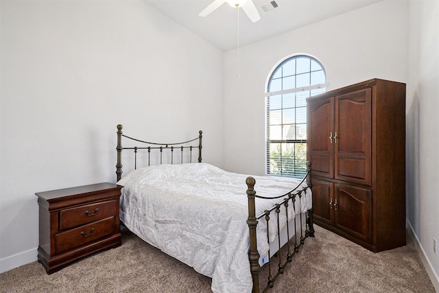 bedroom featuring light carpet, multiple windows, visible vents, and baseboards