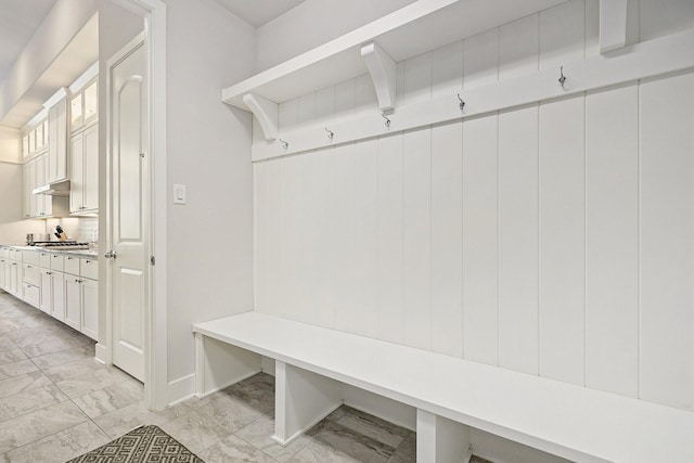 mudroom featuring marble finish floor and baseboards