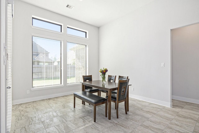 dining space featuring visible vents and baseboards