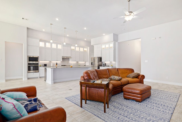 tiled living room with ceiling fan