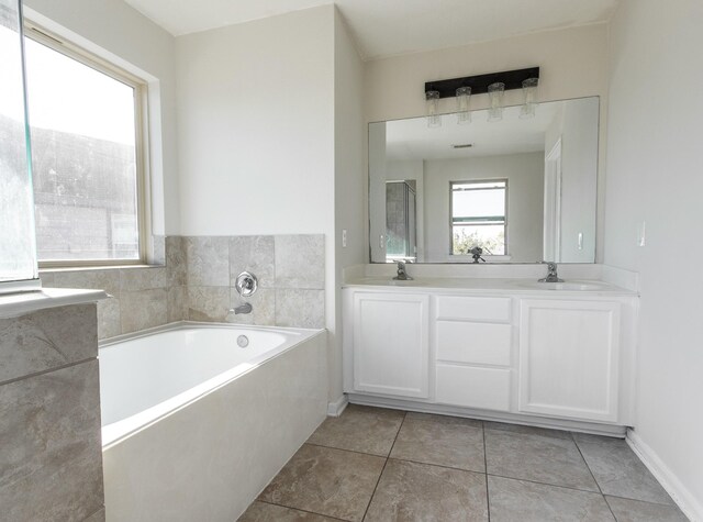 bathroom with vanity, a tub to relax in, and tile patterned floors