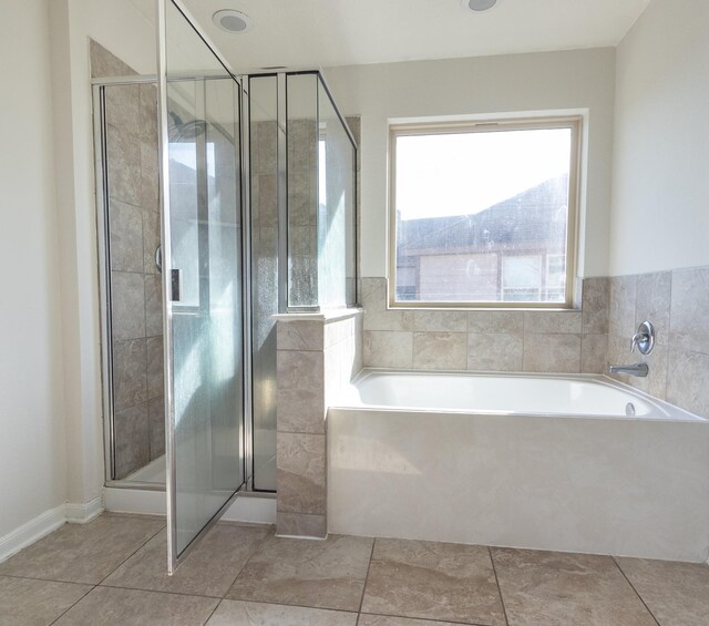 bathroom with plus walk in shower and tile patterned flooring