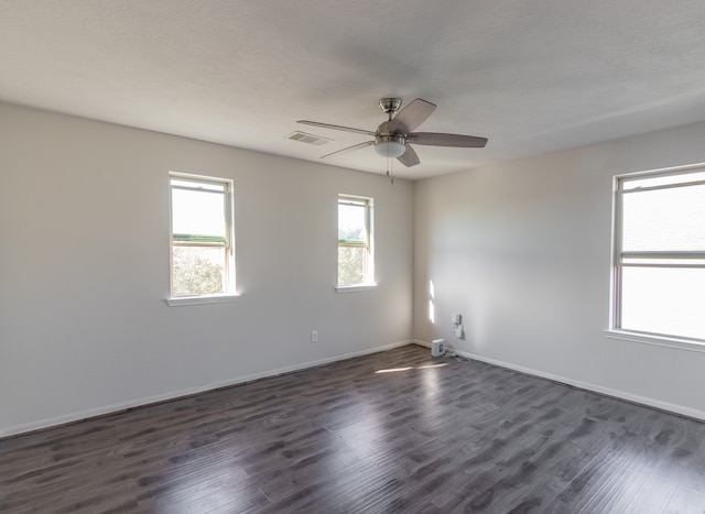 spare room featuring ceiling fan, a textured ceiling, and dark hardwood / wood-style floors