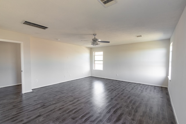 empty room with ceiling fan and dark wood-type flooring