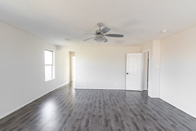 empty room with ceiling fan and dark wood-type flooring