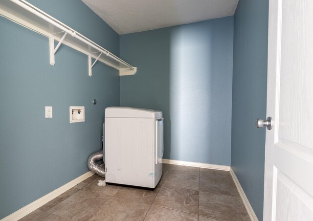 laundry room with tile patterned flooring and washer / dryer