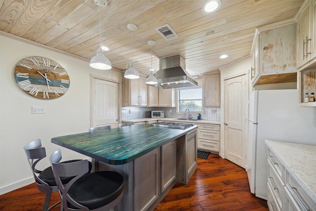 kitchen featuring island range hood, stainless steel gas cooktop, tasteful backsplash, dark hardwood / wood-style floors, and a kitchen island