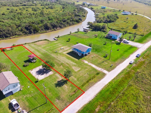 drone / aerial view featuring a water view and a rural view