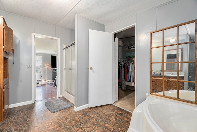 bathroom featuring shower with separate bathtub and a textured ceiling