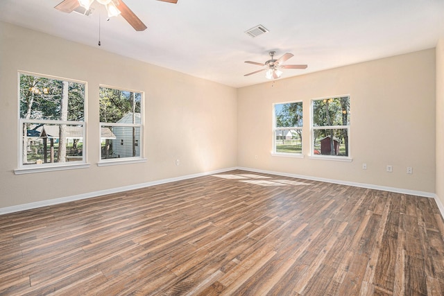 unfurnished room with dark hardwood / wood-style flooring and ceiling fan