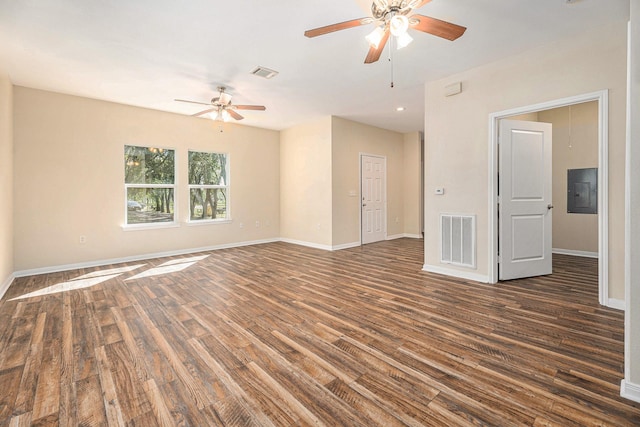 spare room featuring electric panel, ceiling fan, and dark hardwood / wood-style floors