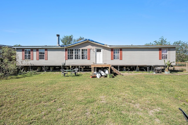 rear view of property featuring a yard