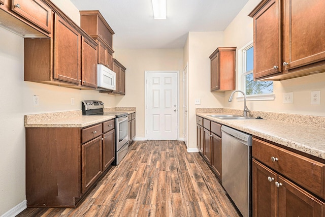 kitchen featuring sink, dark hardwood / wood-style floors, and appliances with stainless steel finishes