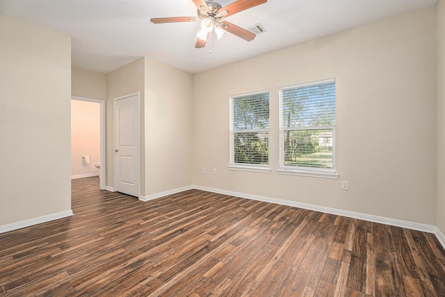 empty room with dark hardwood / wood-style flooring and ceiling fan