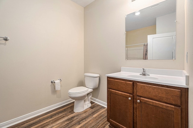 bathroom with a shower with shower curtain, vanity, toilet, and wood-type flooring