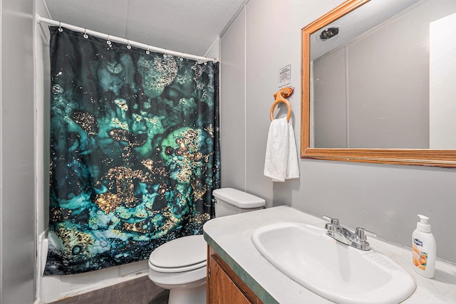 bathroom featuring vanity, a textured ceiling, and toilet