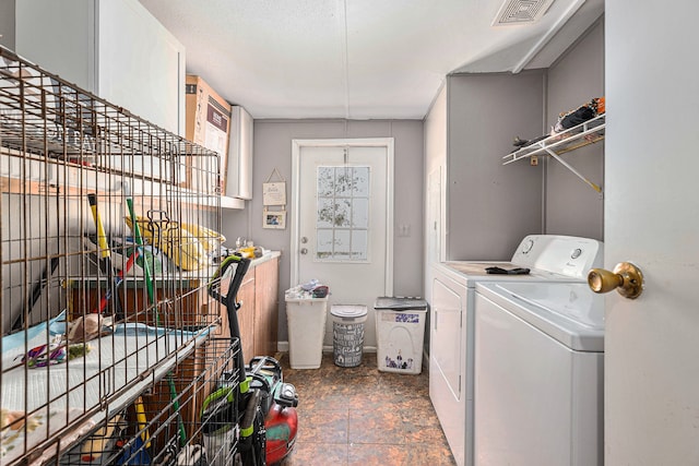 clothes washing area featuring washer and clothes dryer