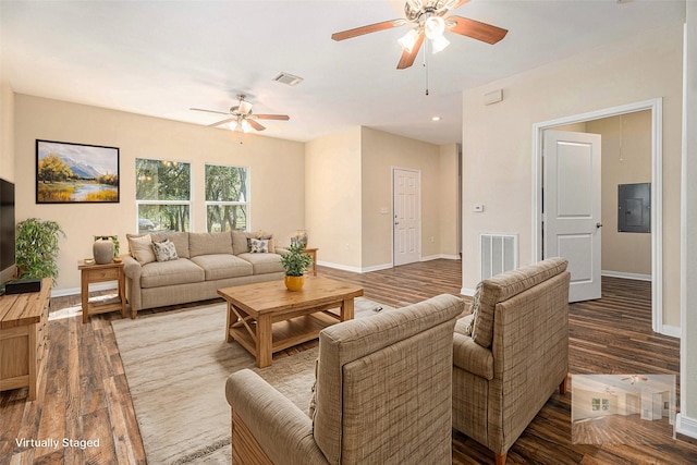 living room featuring electric panel, ceiling fan, and wood-type flooring