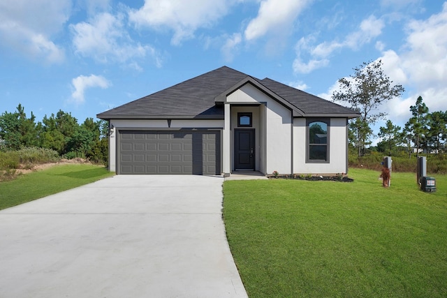 view of front of house featuring a front lawn and a garage