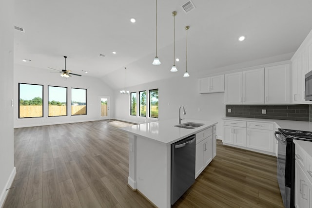 kitchen with sink, lofted ceiling, white cabinetry, a center island with sink, and appliances with stainless steel finishes